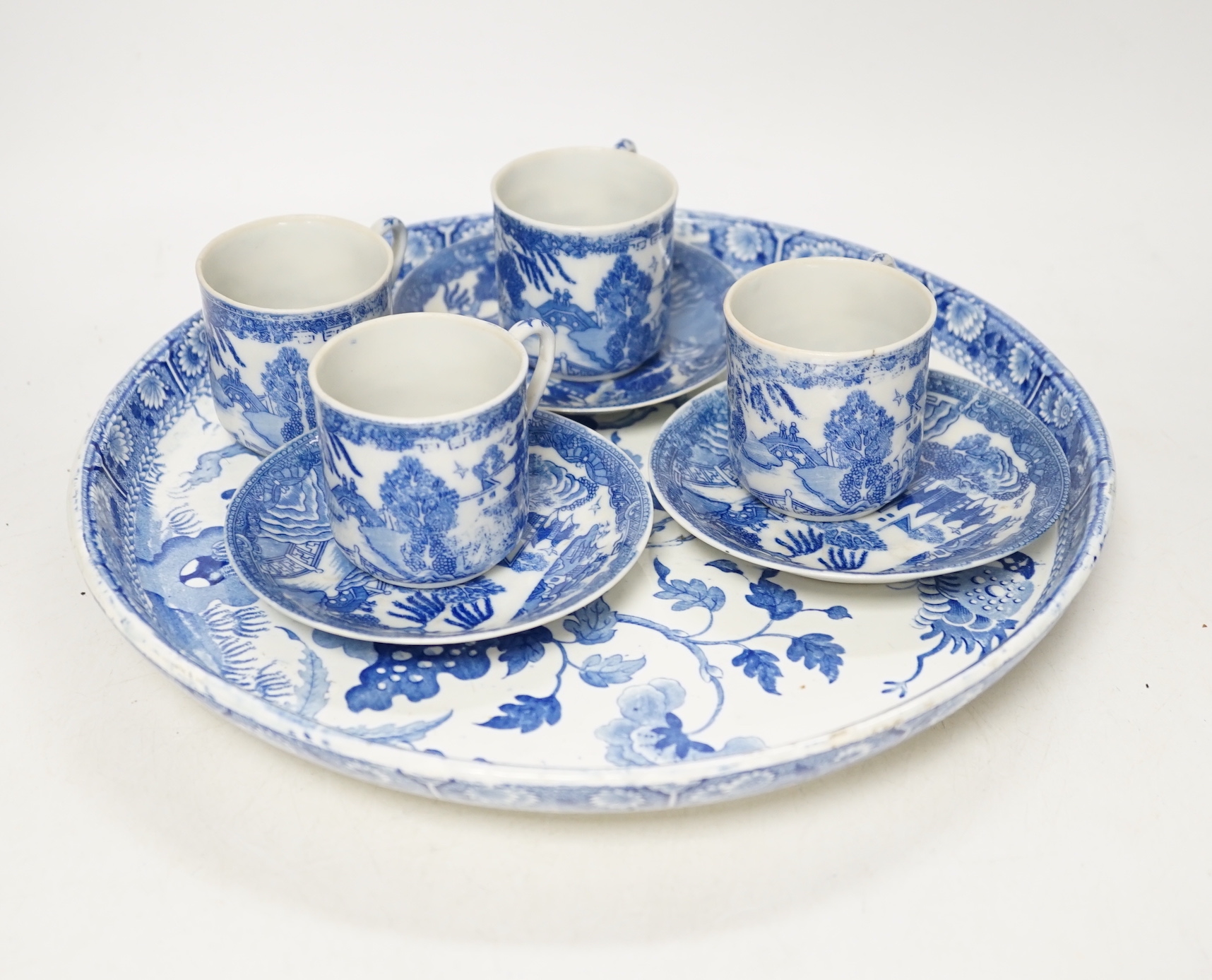 A Japanese blue and white pot coffee set and a 19th century blue and white cheese dish and a Chinese green glass and pewter mounted mug